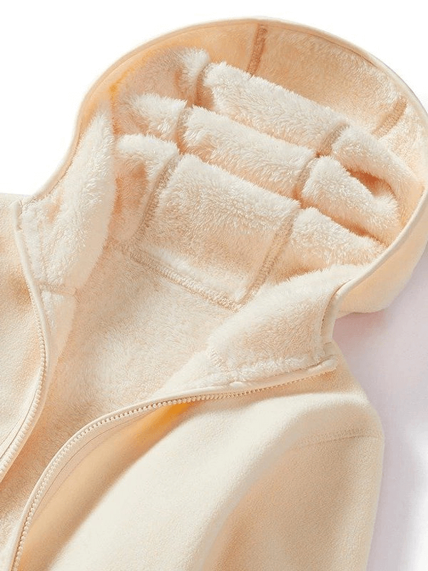 Cream women's reversible fleece jacket with stylish zipper and hood, showcasing cozy interior and quality stitching.